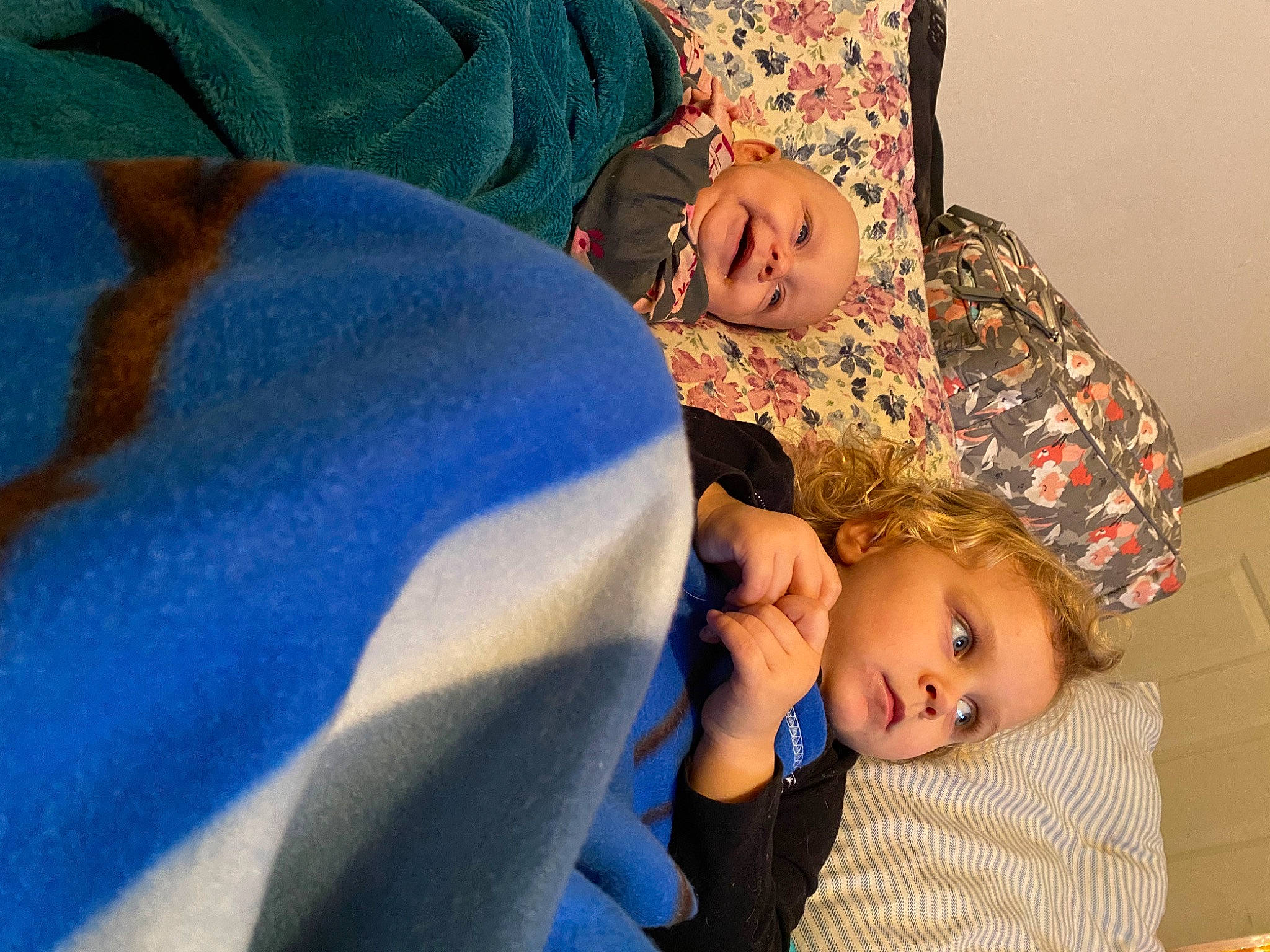 Adalina is registered to the contest to win money with this photo: arm, baby, baby_toddler_clothing, bedtime, blue, cheek, child, comfort, couch, electric_blue, finger, fun, gesture, happy, headwear, joint, linens, mouth, person, sitting