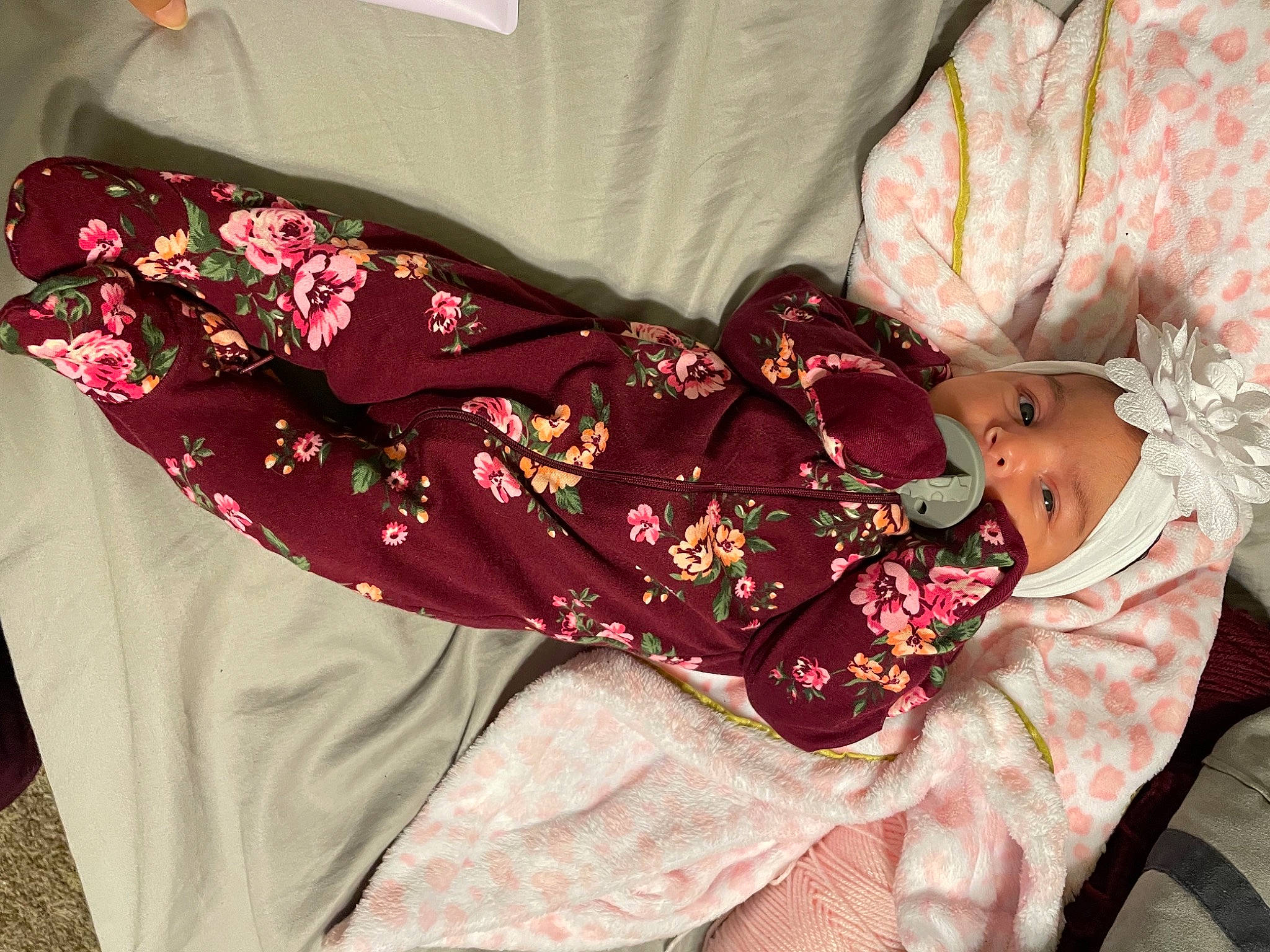 Kamilla is registered to the contest to win money with this photo: baby_products, baby_toddler_clothing, bag, bed_sheet, bedding, comfort, day_dress, embellishment, fashion_accessory, headwear, linens, magenta, pattern, peach, person, pink, product, purple, sleeve, textile