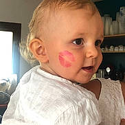 Thiago participe au concours pour gagner de l'argent avec cette photo : background, cheek, child, closeup, curly_hair, cute, ear, expression, face, furniture, holding, human, indoor, lipstick_mark, person, portrait, skin, sleeve, toddler, white_shirt