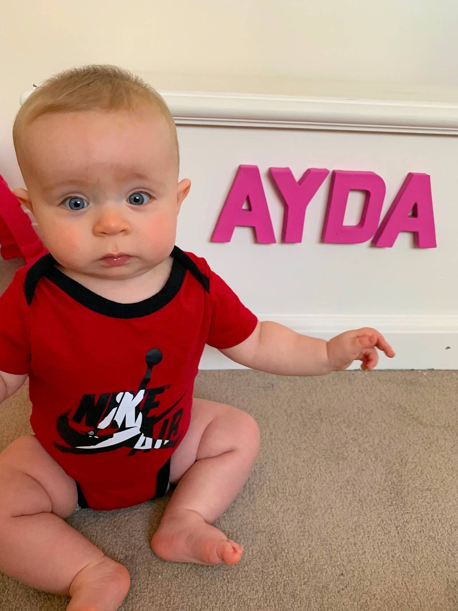 Ayda is registered to the contest to win money with this photo: arm, baby, baby_toddler_clothing, cheek, child, finger, floor, hand, leg, person, pink, play, product, skin, t_shirt, thumb, toddler, vacation