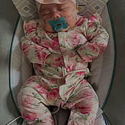 Nyla joined the competition — help win amazing prizes! adorable, baby, baby_rocker, child, cozy, cushion, cute, floral_clothing, headband, indoor, infant, newborn, pacifier, patterned_clothing, peaceful, pink, resting, sleeping, small_person, soft_lighting