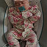 adorable, baby, baby_rocker, child, cozy, cushion, cute, floral_clothing, headband, indoor, infant, newborn, pacifier, patterned_clothing, peaceful, pink, resting, sleeping, small_person, soft_lighting