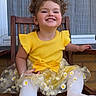 child, toddler, smiling, yellow_dress, daisies, white_tights, wooden_chair, outdoor, happy, cute, portrait, sitting, playful, girl, clothing, window, background, hair, fun, dirt