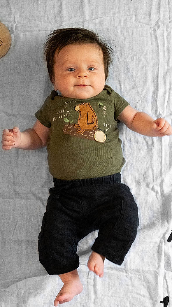 Barrett is registered to the contest to win money with this photo: arm, baby_toddler_clothing, cheek, chin, eye, face, facial_expression, hairstyle, hand, head, human_body, joint, leg, neck, nose, outerwear, person, shoulder, skin, sleeve