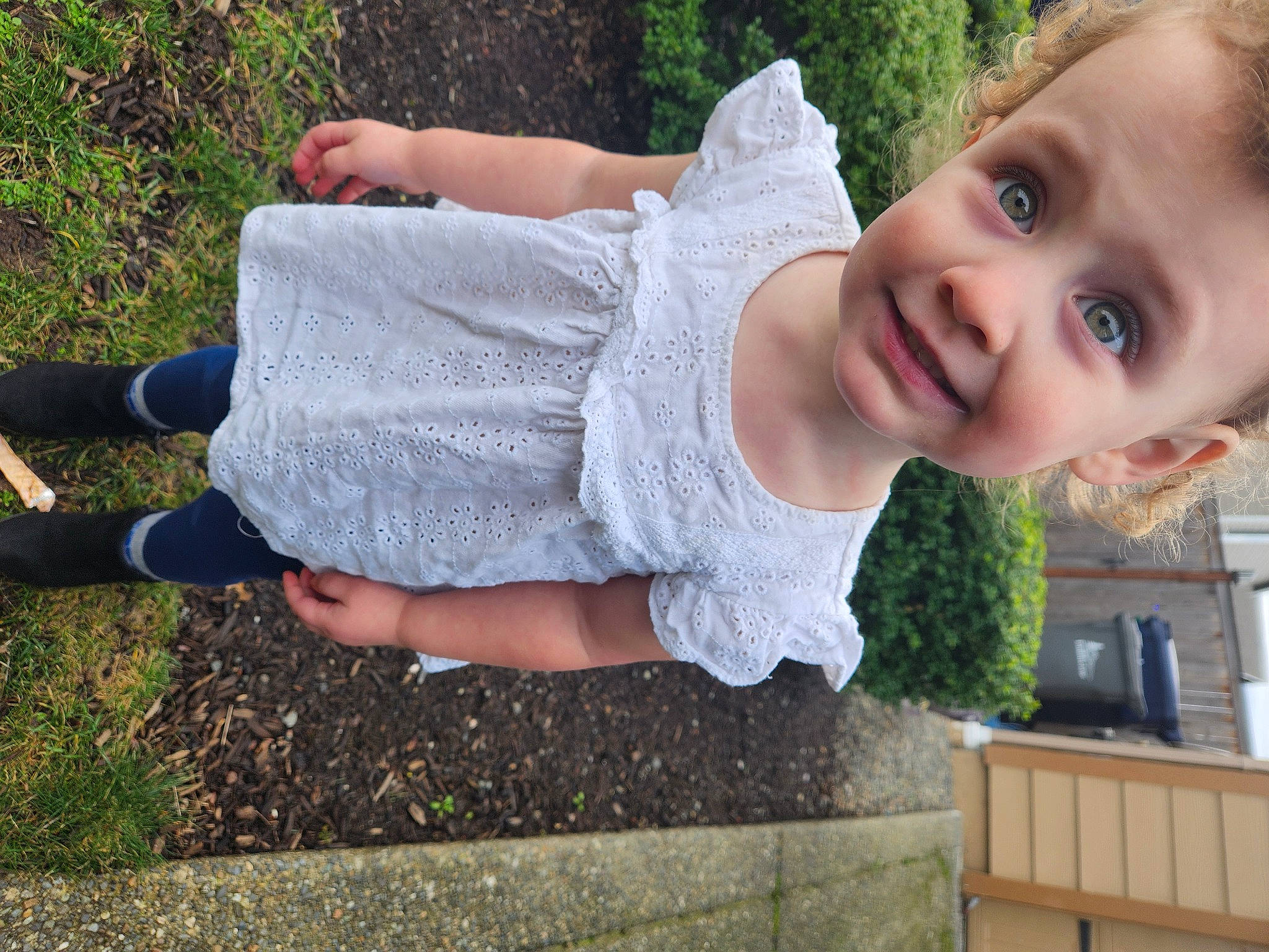 Marley is registered to the contest to win money with this photo: baby, baby_toddler_clothing, child, dress, fun, garden, grass, happy, human_leg, joy, leisure, pattern, people_in_nature, person, plant, play, recreation, sitting, sleeve, smile