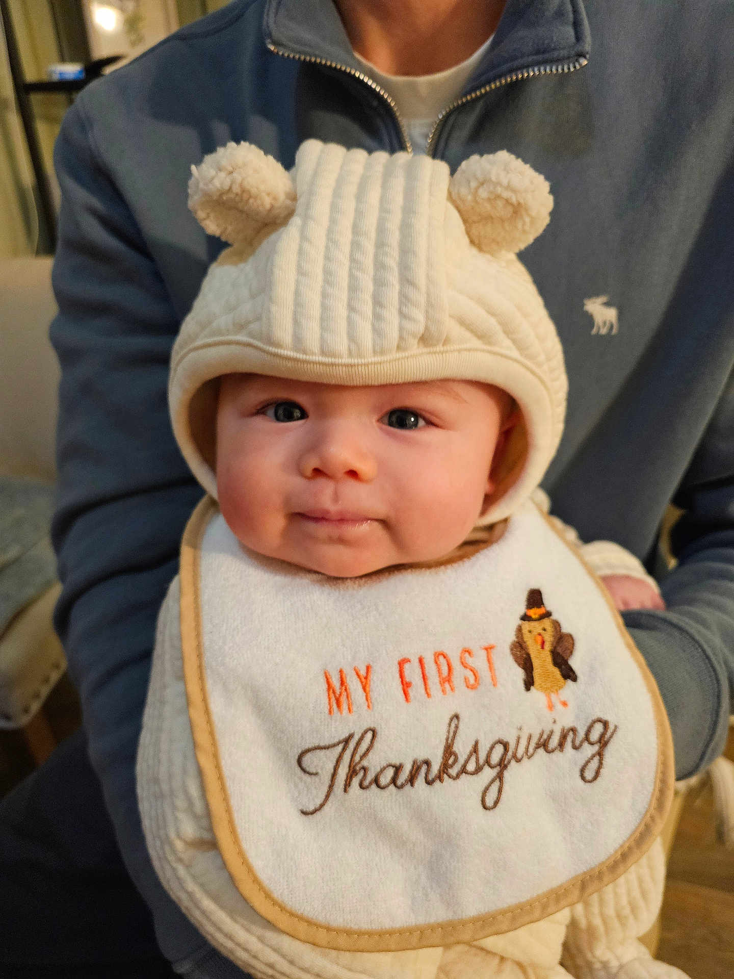 Zeke joined the competition — help win amazing prizes! baby, infant, bib, hat, bear_ears, thanksgiving, child, person, clothing, sweater, portrait, indoor, cute, holiday, family, smile, face, young_child, warm, holding