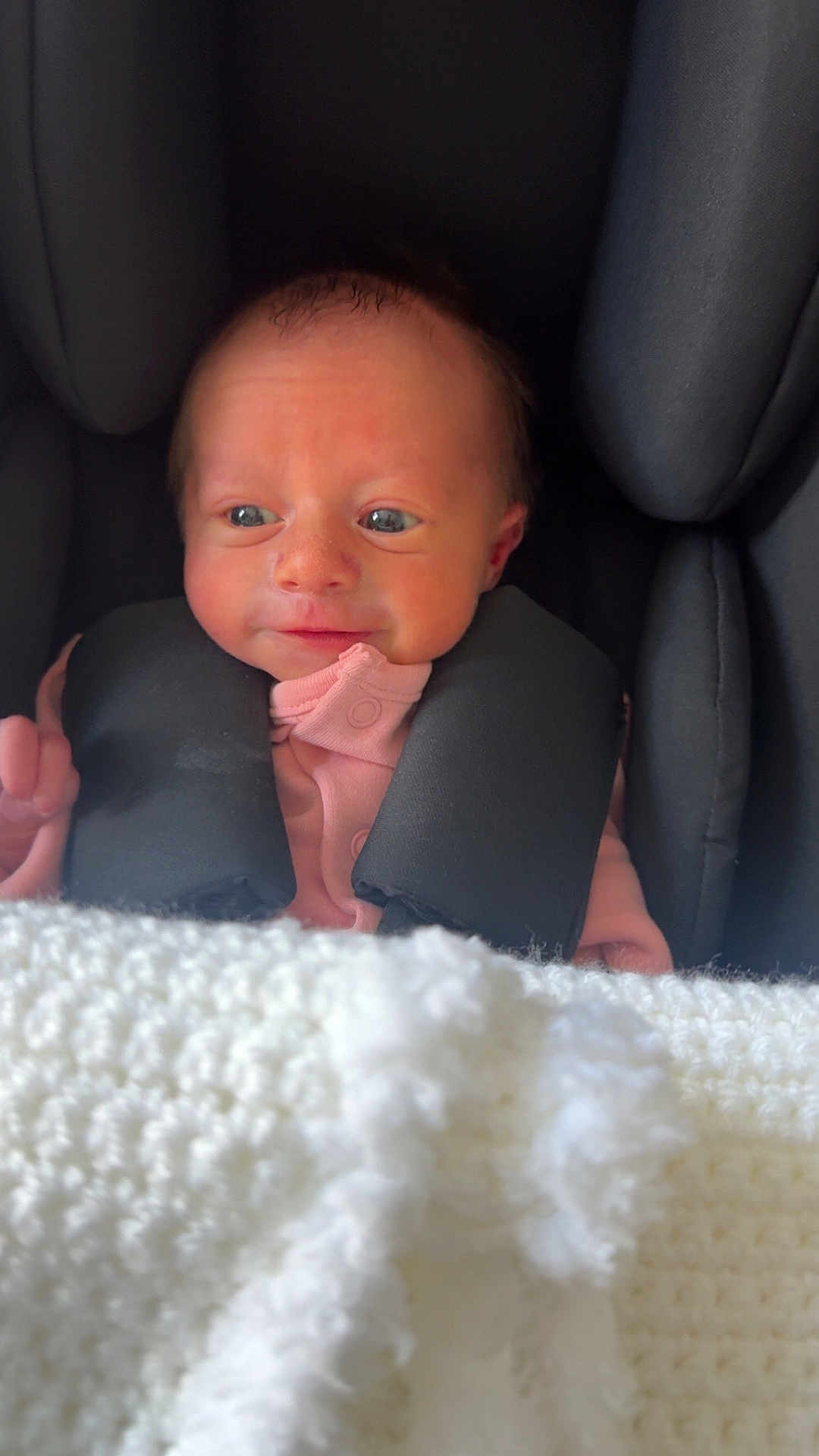Cătalină joined the competition — help win amazing prizes! baby, infant, car_seat, blanket, pink_clothing, face, head, human, child, newborn, seat, safety, comfort, portrait, expression, indoor, soft_texture, cozy, cute, resting