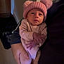 Cătalină joined the competition — help win amazing prizes! baby, infant, pink_clothing, hat, pom_pom, person, indoor, holding, cute, newborn, warm_clothing, soft_lighting, adult_hand, portrait, human, face, cozy, child, sleepwear, newborn_baby