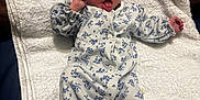 Cătalină joined the competition — help win amazing prizes! baby, blue, cute, expression, eyes_open, face, floral_pattern, indoor, infant, lying_down, mouth_open, newborn, onesie, portrait, skin, sleepwear, small_feet, small_hands, towel, white_towel