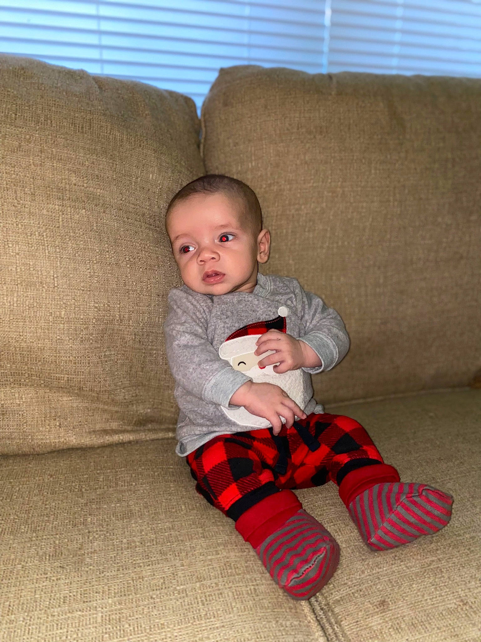 Emerson joined the competition — help win amazing prizes! baby, baby_toddler_clothing, carmine, child, comfort, couch, eye, face, flooring, hardwood, lap, pattern, person, plaid, sitting, sleeve, sock, tartan, toddler, window_blind