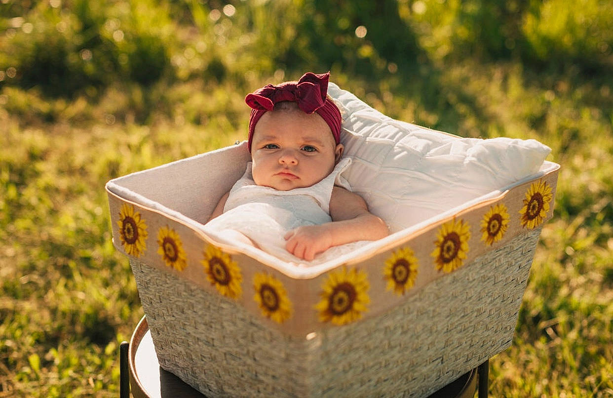 Alaynah is registered to the contest to win money with this photo: baby, baby_products, baby_toddler_clothing, basket, child, dress, eye, eyewear, face, fashion_accessory, fun, grass, happy, head, headgear, headwear, leisure, people_in_nature, person, plant