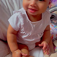 Aurora joined the competition — help win amazing prizes! baby, bed, blanket, child, cozy, cute, face, footwear, hand, happy, indoors, infant, leg, person, portrait, sitting, skin, smile, toy, white_clothing