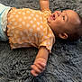 Aurora joined the competition — help win amazing prizes! baby, child, clothing, cute, expression, floral_pattern, footwear, gray_rug, hand, happy, head, indoor, infant, lying_down, orange_shirt, person, portrait, skin, smiling, wedge_sandals