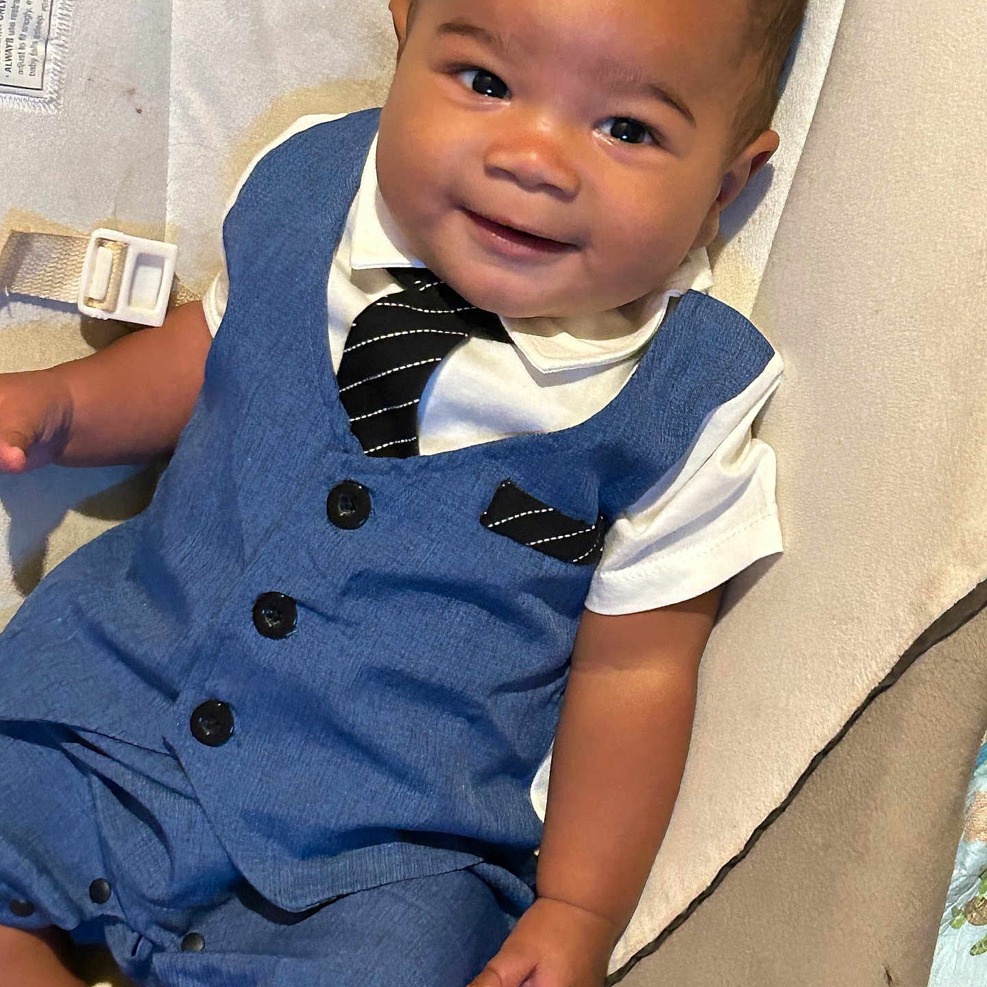 Ayden is registered to the contest to win money with this photo: accessories, baby, blazer, clothing, coat, dress, face, formalwear, happy, head, jeans, pants, person, photography, portrait, shirt, sitting, suit, tie, vest