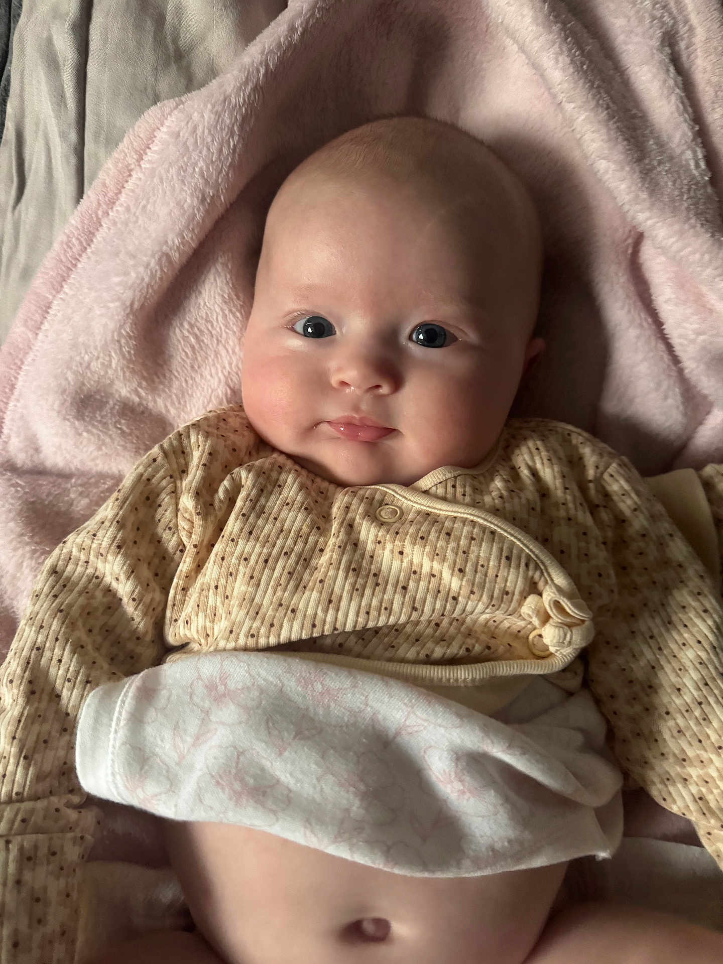 Raya is registered to the contest to win money with this photo: baby, infant, face, eyes, skin, blanket, clothing, newborn, cute, portrait, lying_down, soft_texture, indoors, warm, child, adorable, human, closeup, peaceful, comfort