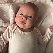 Raya is registered to the contest to win money with this photo: baby, infant, face, eyes, blanket, clothing, onesie, soft, cute, newborn, skin, head, lying, portrait, child, expression, pink, cozy, indoor, person