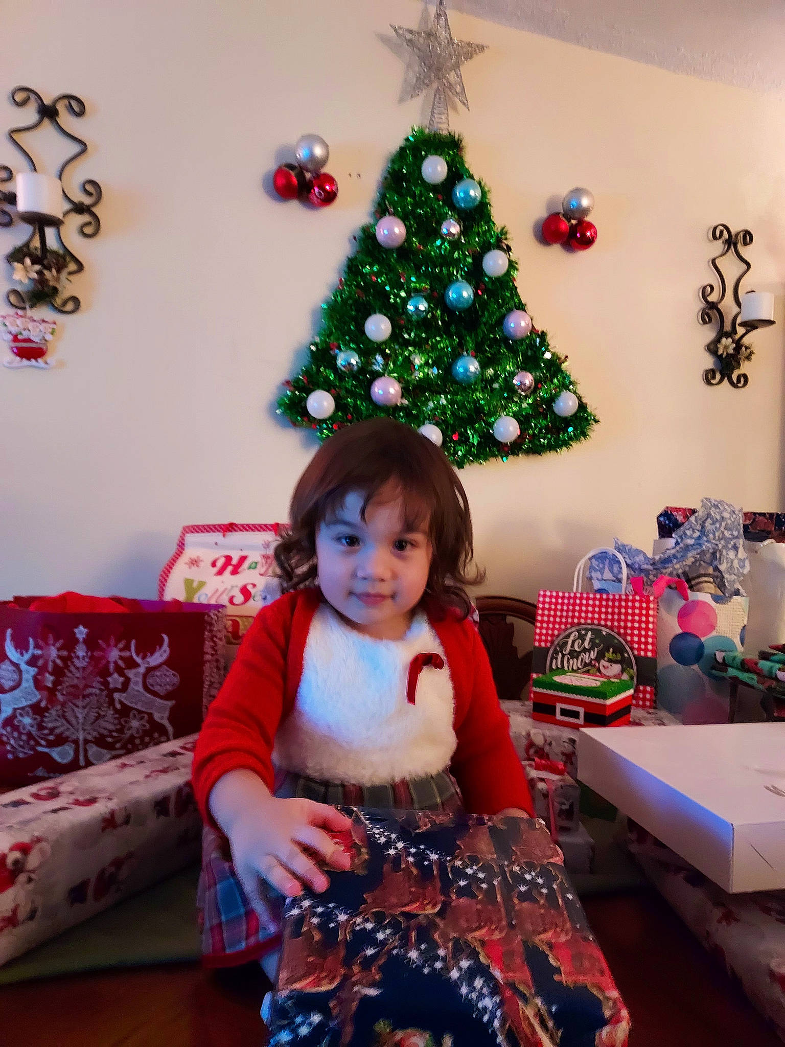 Amelia joined the competition — help win amazing prizes! baby_toddler_clothing, black, blue, christmas, christmas_decoration, christmas_ornament, christmas_tree, decoration, green, holiday_ornament, interior_design, living_room, ornament, person, pink, plant, red, sleeve, textile, tree
