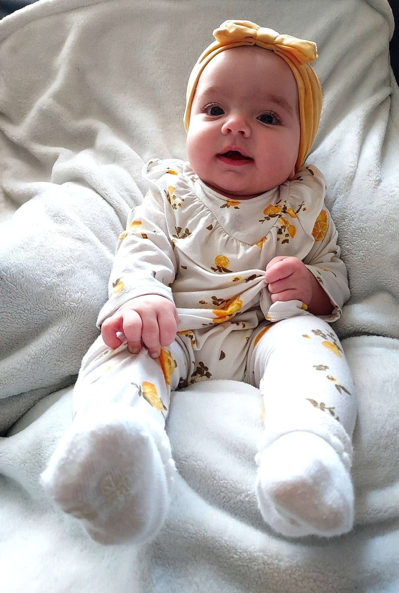 Mila is registered to the contest to win money with this photo: baby, baby_products, baby_safety, baby_toddler_clothing, cheek, child, comfort, eye, face, fun, happy, head, iris, linens, person, portrait_photography, sitting, skin, sleeve, smile
