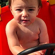Mason joined the competition — help win amazing prizes! toddler, child, toy_car, steering_wheel, outdoor, sunlight, red, yellow, skin, hands, face, hair, expression, play, summer, daylight, cute, young, person, vehicle