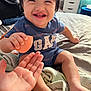 Zayden joined the competition — help win amazing prizes! toddler, smiling, child, bed, blanket, hand, furniture, clothing, indoor, happy, person, face, foot, drawer, towel, room, holding, skin, toy, casual
