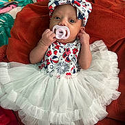 Leeana joined the competition — help win amazing prizes! baby, infant, pacifier, headband, bow, tutu, dress, blanket, patterned_clothing, red, white, blue, lying_down, cute, small_hands, indoor, fabric, colorful, soft_texture, person