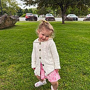 Maggie joined the competition — help win amazing prizes! child, toddler, girl, portrait, outdoor, park, grass, lawn, smiling, playful, standing, cardigan, pink_shorts, sneakers, ponytail, trees, boulders, parked_cars, cloudy_sky, nature