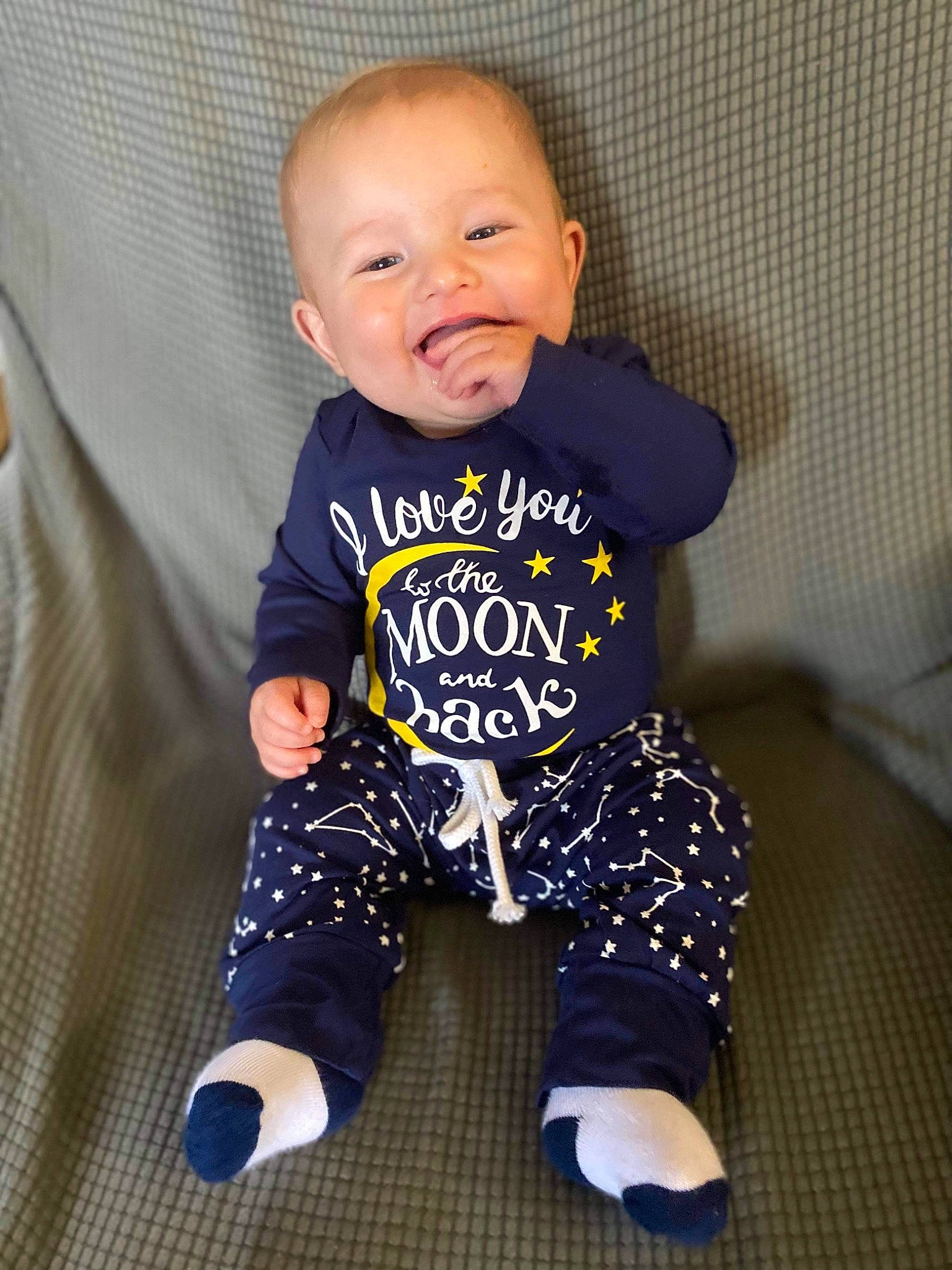 Leroy is registered to the contest to win money with this photo: baby, baby_toddler_clothing, cheek, child, clothing, comfort, eye, face, flooring, hair, happy, head, iris, outerwear, person, product, skin, sleeve, smile, t_shirt