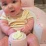 baby, infant, child, pink, inflatable_chair, bunny_print, strawberry_print, sippy_cup, curious, indoor, furniture, high_chair, window_blinds, cute, smiling, seated, person, soft_lighting, close_up, plush