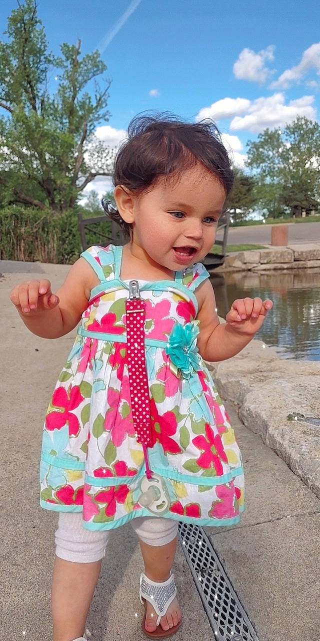 Willow is registered to the contest to win money with this photo: baby, baby_toddler_clothing, child, clothing, cloud, day_dress, dress, gesture, grass, hand, happy, leisure, person, pink, skin, sky, sleeve, summer, toddler, tree