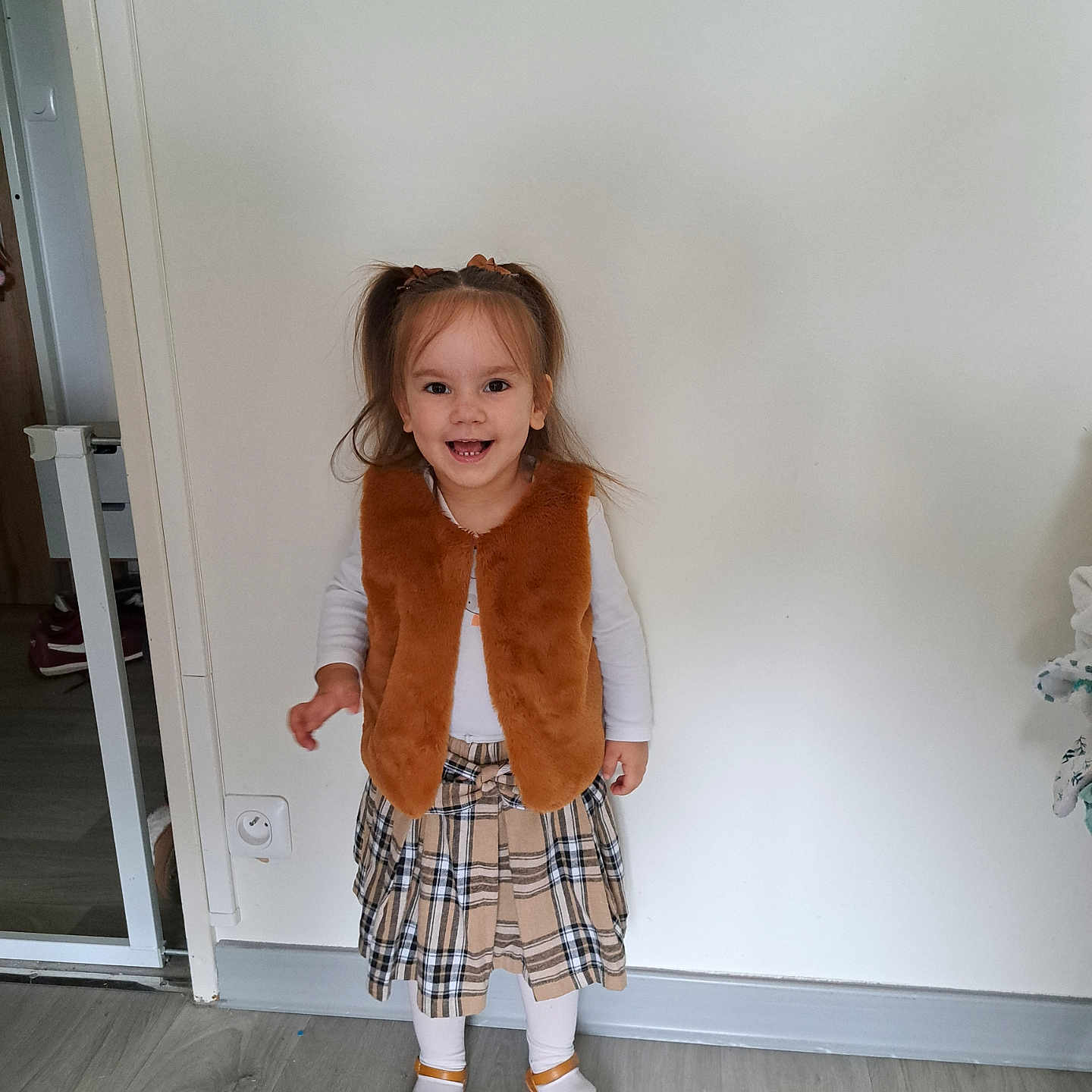 Eléa participe au concours pour gagner de l'argent avec cette photo : child, clothing, door, dress, face, female, footwear, girl, hardwood, head, longsleeve, pants, person, photography, portrait, sandal, shoe, shorts, skirt, wood