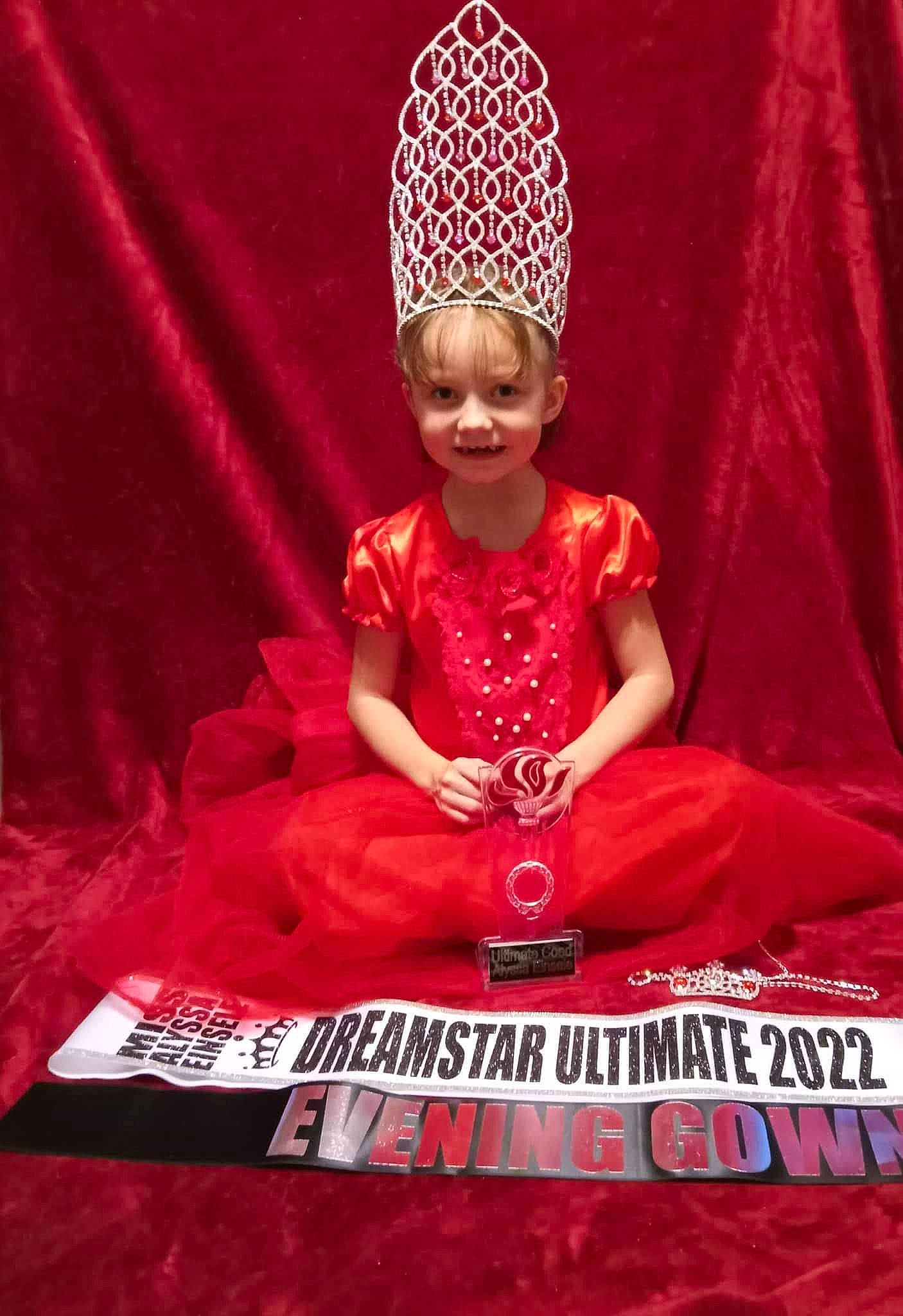 Alyssa joined the competition — help win amazing prizes! book, carmine, crown, entertainment, event, fashion_design, flesh, font, happy, headpiece, magenta, person, pink, sleeve, smile, t_shirt, toddler, tradition, turban