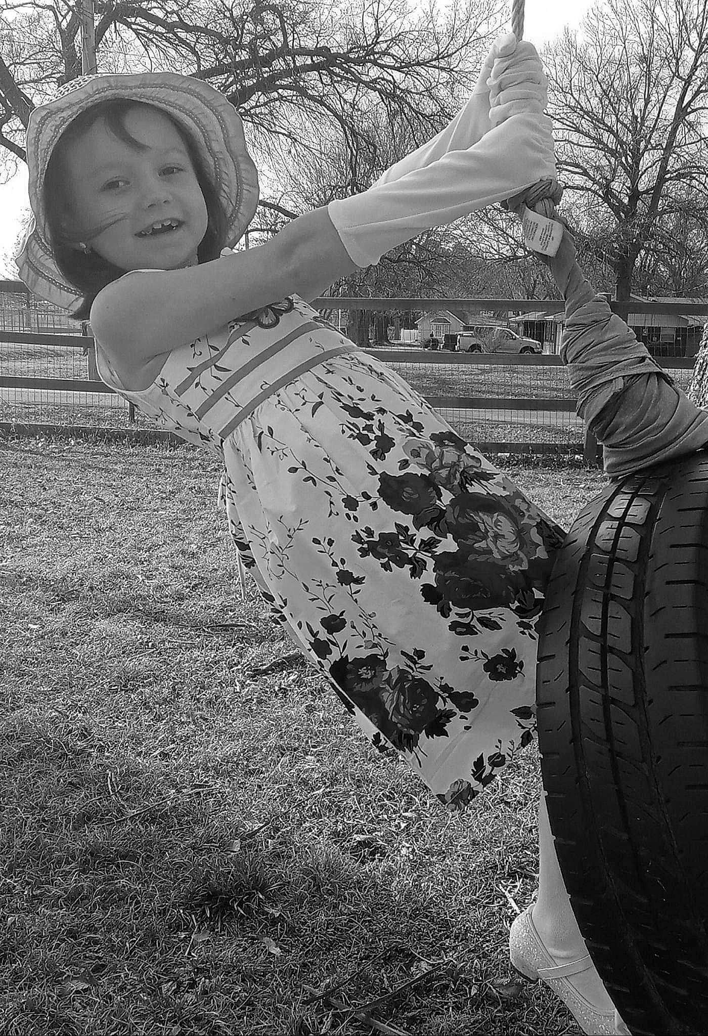 Alyssa joined the competition — help win amazing prizes! automotive_tire, black, black_and_white, flash_photography, gesture, grass, grassland, hand, happy, headgear, joy, landscape, monochrome, people_in_nature, person, plant, smile, style, tints_and_shades, tire