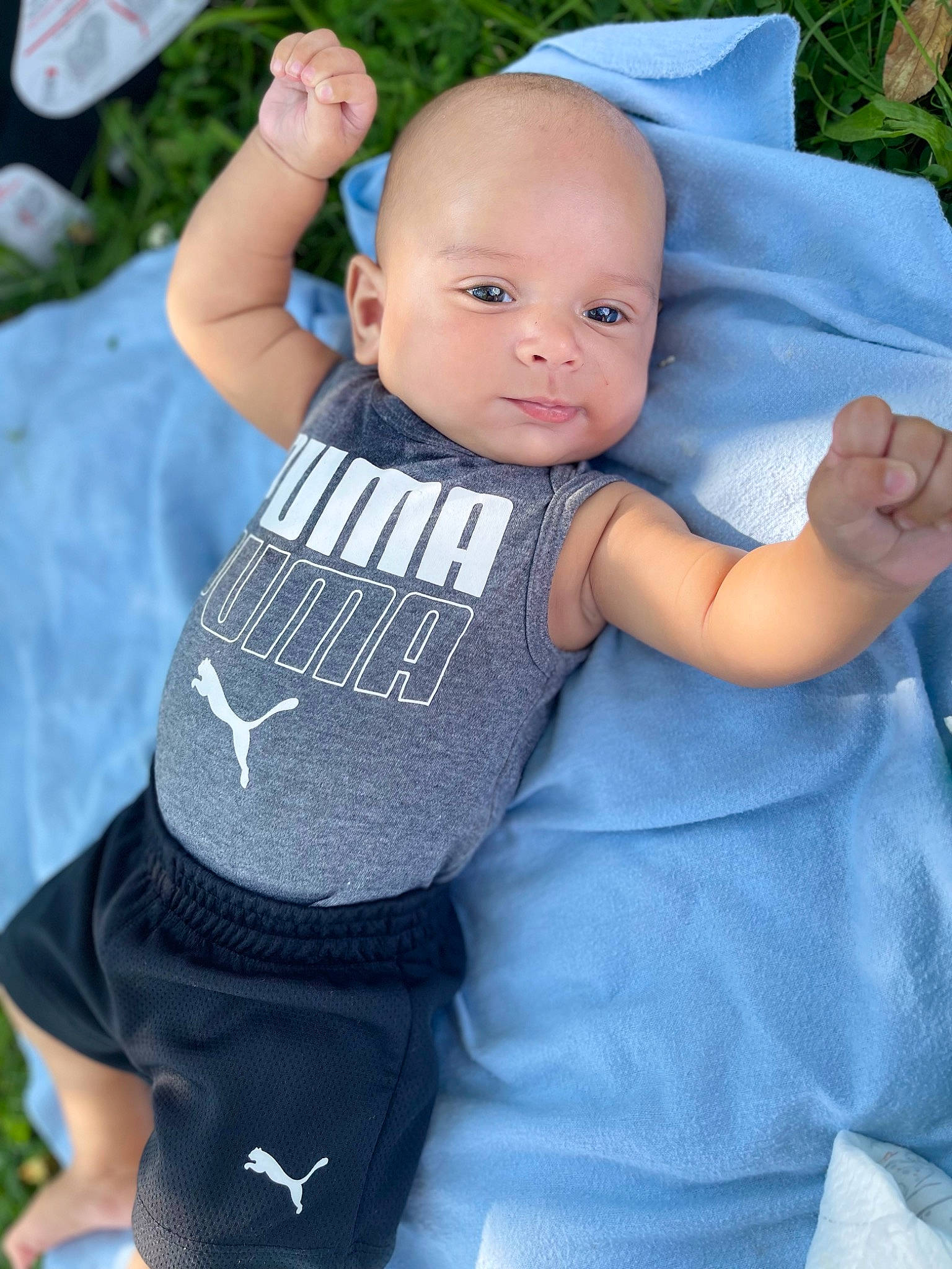 Camari is registered to the contest to win money with this photo: abdomen, arm, azure, baby, baby_products, baby_toddler_clothing, chest, electric_blue, face, finger, gesture, grey, hand, happy, person, skin, sleeve, t_shirt, textile, toddler