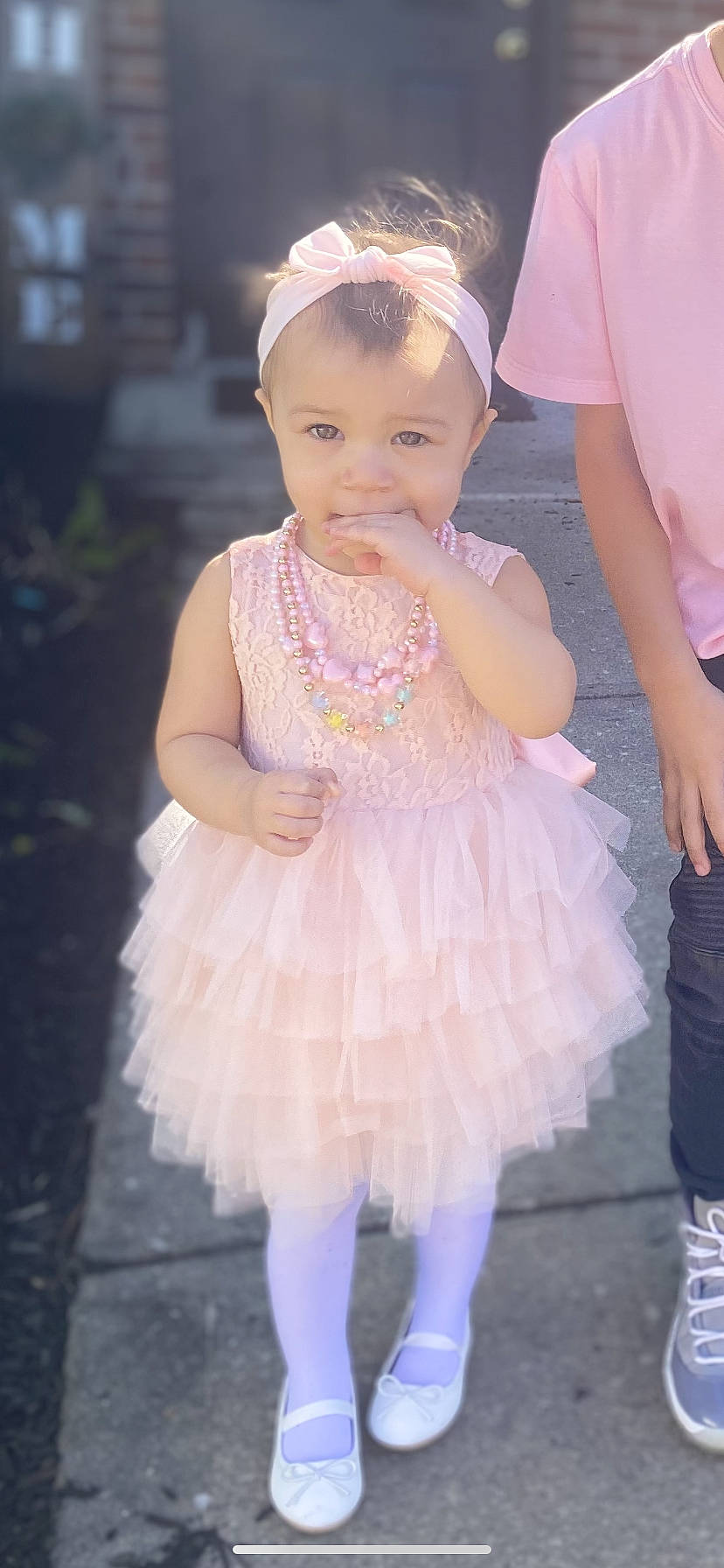 Cahlani is registered to the contest to win money with this photo: baby, baby_toddler_clothing, child, day_dress, embellishment, event, flash_photography, formal_wear, fun, gesture, happy, iris, person, pink, purple, ruffle, skin, smile, standing, toddler