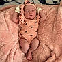 baby, sleeping, pink_blanket, peach_outfit, heart_pattern, headband, mittens, infant, soft_texture, cozy, resting, cute, newborn, portrait, child, blanket, comfort, adorable, peaceful, relaxation
