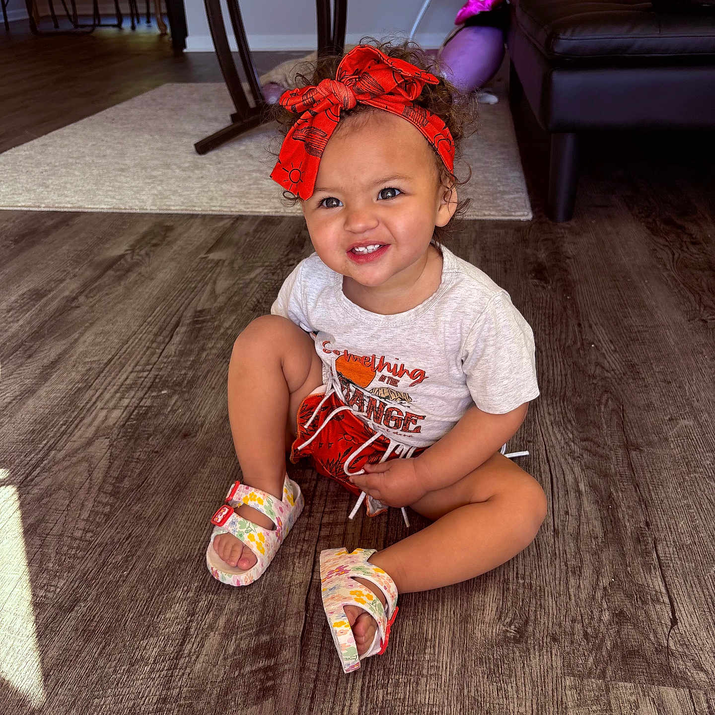 Maeliana is registered to the contest to win money with this photo: architecture, building, child, clothing, couch, face, female, footwear, furniture, girl, hardwood, head, indoors, person, photography, portrait, sandal, shoe, sitting, wood