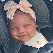 Ja'Layah is registered to the contest to win money with this photo: baby, smiling, headband, pink_bow, car_seat, infant, child, cute, happiness, straps, clothing, face, seatbelt, young, adorable, closeup, portrait, safety, comfort, happy