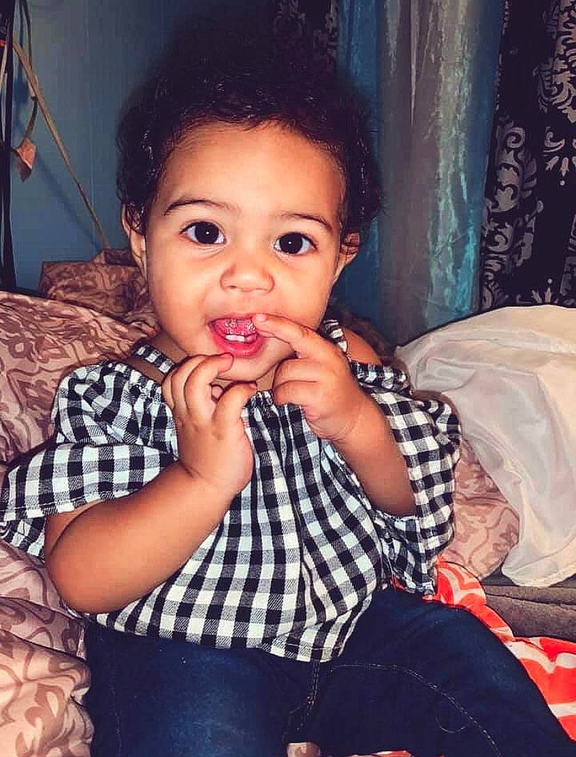 Aubriana is registered to the contest to win money with this photo: black_hair, cheek, child, eating, eye, face, lip, nose, person, toddler