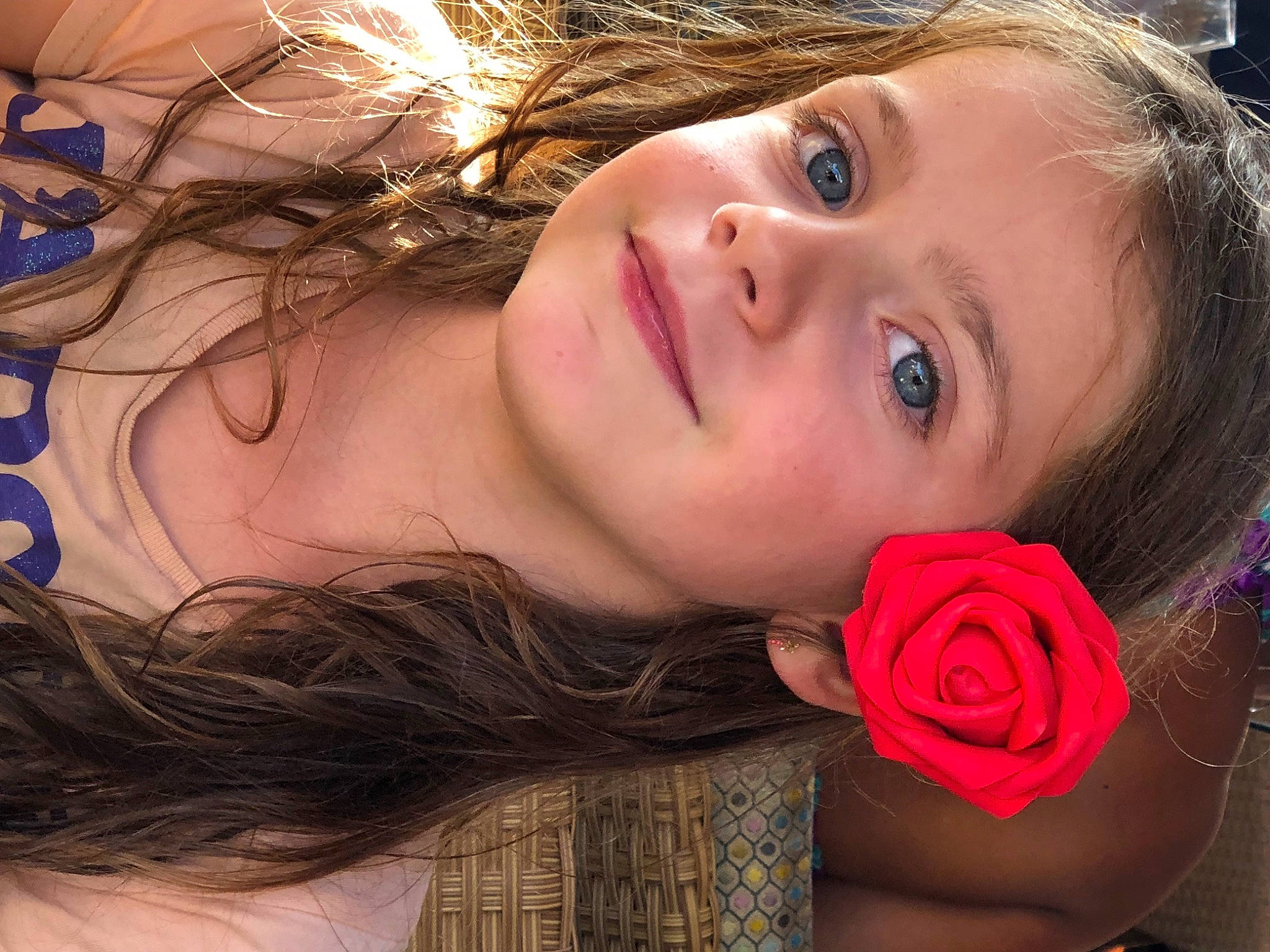 Charlotte participe au concours pour gagner de l'argent avec cette photo : black_hair, cheek, chin, cool, eyebrow, eyelash, flash_photography, flower, forehead, happy, iris, joy, lip, long_hair, mouth, neck, nose, person, petal, rose