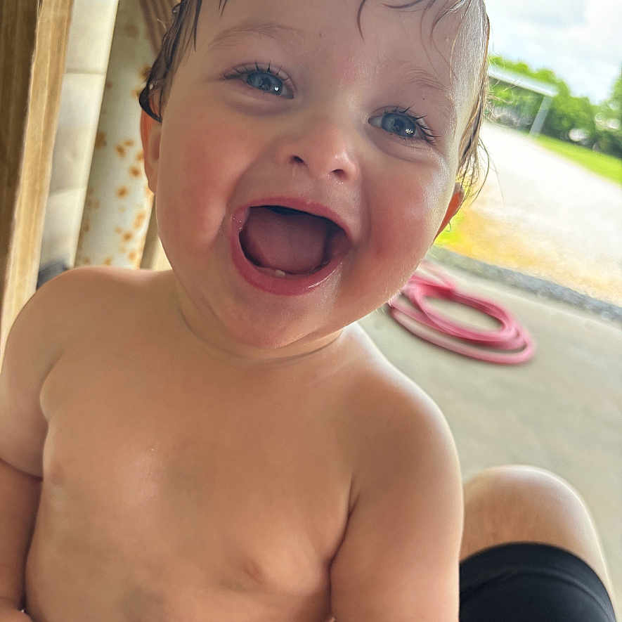 August joined the competition — help win amazing prizes! baby, babylaughing, bodypart, clothing, dress, face, finger, hand, happy, head, laughing, mouth, neck, newborn, person, photography, portrait, smile, teeth, tongue