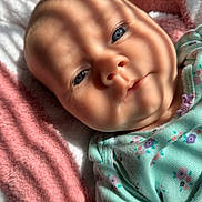 Vaeda joined the competition — help win amazing prizes! baby, infant, face, blue_eyes, blanket, striped_shadow, soft_texture, clothing, floral_pattern, cute, child, portrait, lying_down, skin, head, newborn, sleepy, indoors, closeup, warm_light