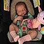 Vaeda joined the competition — help win amazing prizes! baby, car_seat, sleeping, pink_socks, onesie, plush_toy, unicorn, safety_harness, infant, child, soft_padding, peaceful, cute, indoor, closeup, resting, head_support, warning_labels, hand, footwear