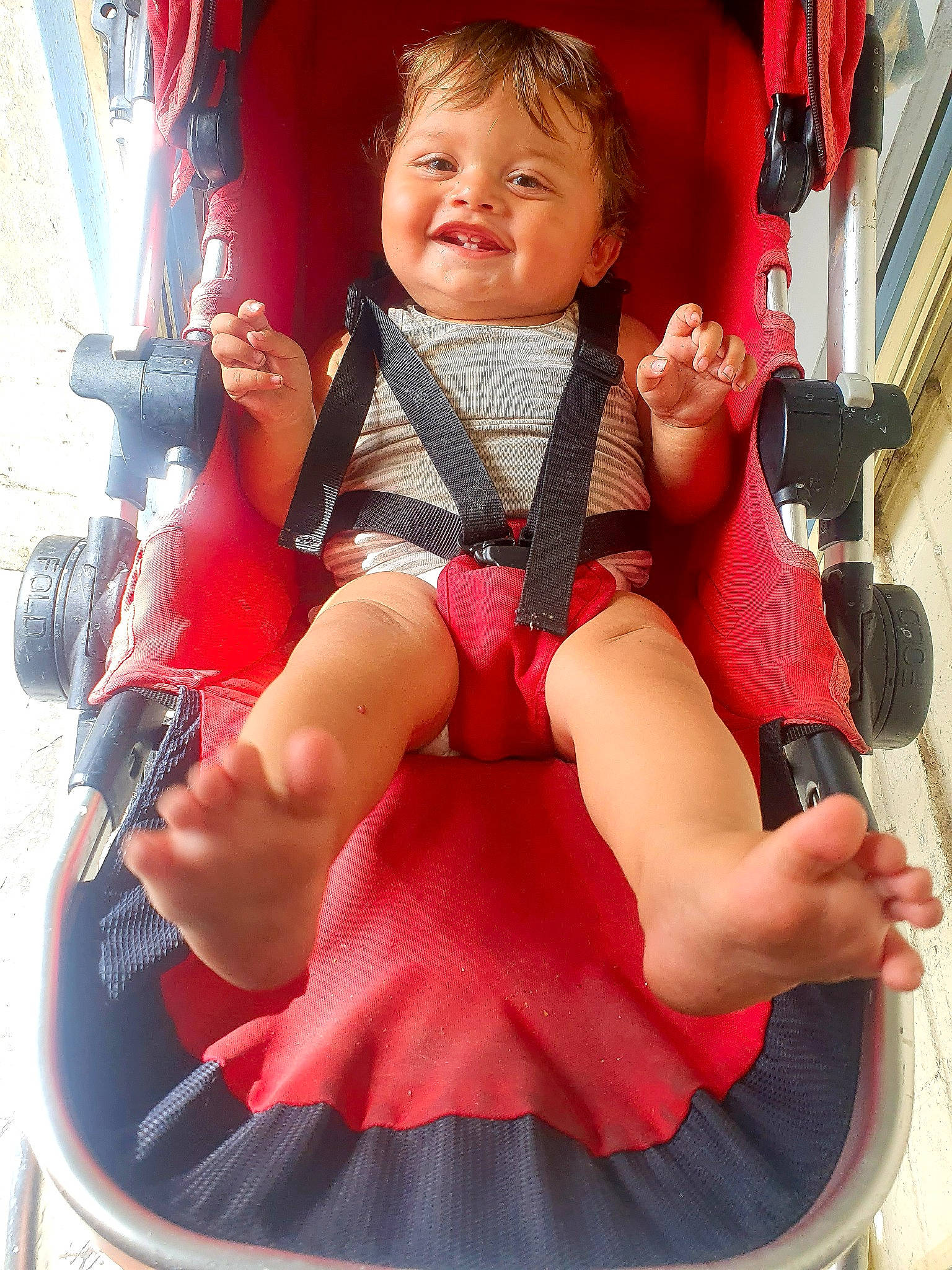 Geoffrey is registered to the contest to win money with this photo: baby, baby_carriage, baby_products, baby_toddler_clothing, comfort, fun, happy, human_leg, joy, knee, lap, leg, leisure, person, pink, recreation, shorts, skin, smile, thigh
