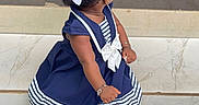 Jazlynn joined the competition — help win amazing prizes! child, toddler, girl, sitting, dress, navy_blue, white, striped_clothing, hair_bows, curly_hair, braids, hairstyle, bracelet, earring, sparkly_shoes, socks, indoor, tile_floor, portrait, fashion