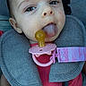 baby, infant, pacifier, tongue, car_seat, seatbelt, harness, pink_clothing, close_up, child, face, cute, playful, young_child, safety, seat, child_seat, expression, person, baby_girl