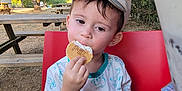 Adelin participe au concours pour gagner de l'argent avec cette photo : biscuit, boy, cap, casual, child, cream, daylight, dessert, forest, glass, hand, lion_king, nature, outdoor, picnic_table, red_chair, summer, tree, tshirt, wood