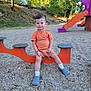 Adelin a rejoint le concours — aidez-le/la à gagner de superbes lots ! casual, child, daytime, gravel, happy, nature, orange_clothing, outdoor, park, person, play_equipment, playground, recreation, shoes, slide, smile, socks, sunlight, toddler, trees