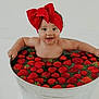 baby, child, red_bow, headband, strawberries, metal_tub, water, happy, smiling, cute, infant, fruit, bath, playful, indoors, skin, arms, sitting, fresh, fun