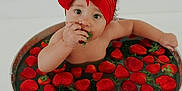 Peyton is registered to the contest to win money with this photo: baby, child, strawberries, red_bow, headband, bucket, water, fruit, cute, indoors, portrait, skin, hand, sitting, food, fresh, healthy, playful, sweet, innocent