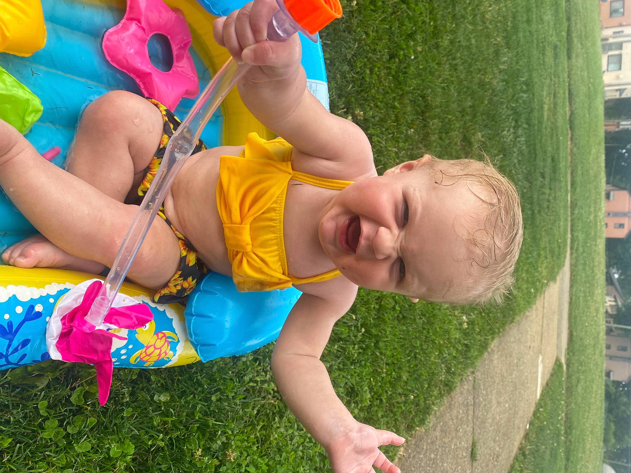 Nellie joined the competition — help win amazing prizes! baby, child, event, fun, grass, green, happy, head, human_leg, leisure, outdoor_play_equipment, people_in_nature, person, recreation, red, shorts, smile, summer, thigh, toddler